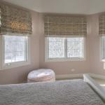 Beautiful Blush Ensuite Bedroom with designer wallcovering, custom floral roman hobble shades, bedding and pillows. Batavia, IL Residence