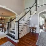 A stately, foyer with grand staircase was created by removing the runner, painting the risers and adding a dark wood stain. Residence, Batavia, IL (Tanglewood Hills)
